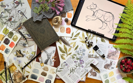 artist Bevin Marie's desk full of seasonal art, flowers, branches, paints
